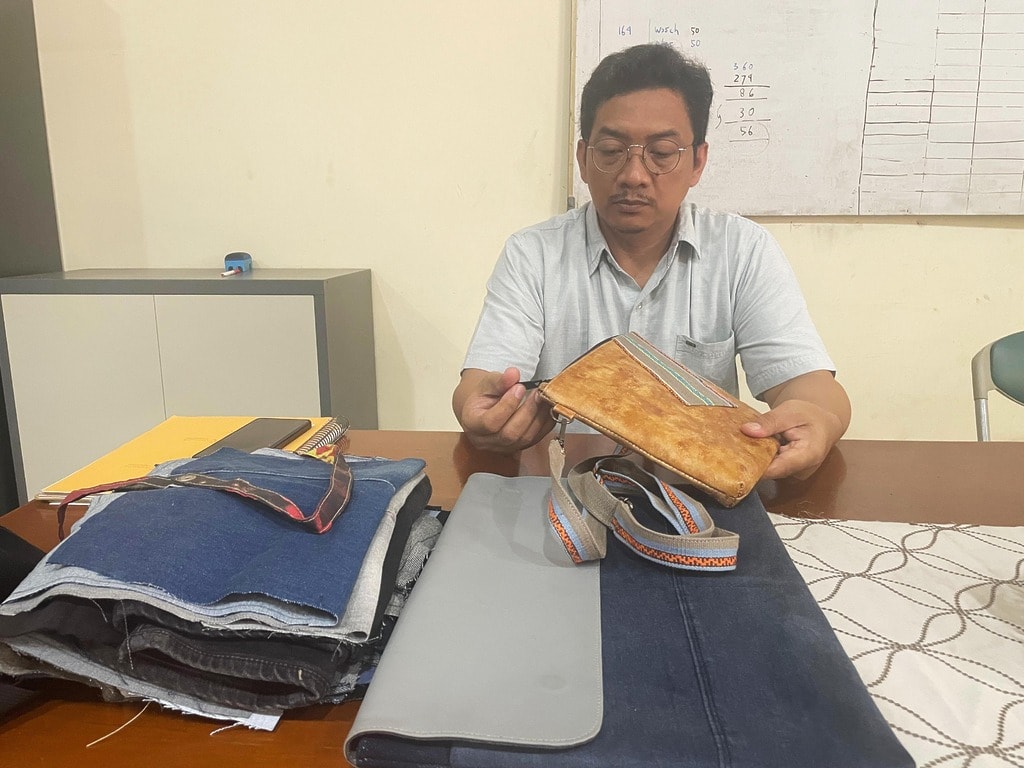 Ramli, Manager at XSProjek, is reviewing the quality of the finished custom products.