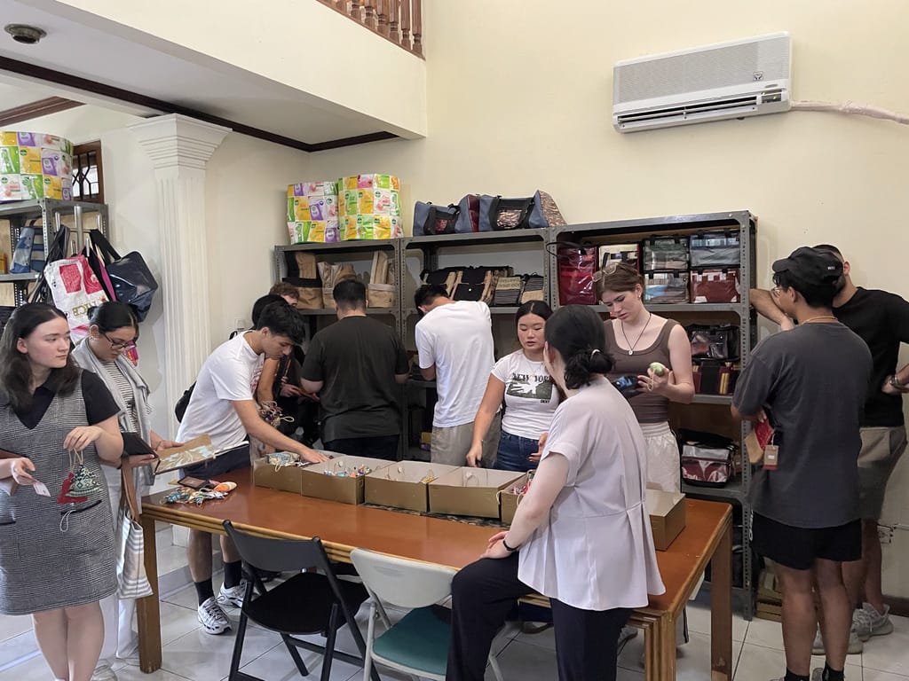 Students from the Business School - University of Sydney with Prof. Jeaney looking at XSProjek upcycled products made from waste materials.