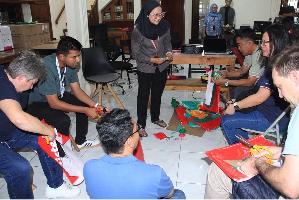 participants are asked to cut the fabric according to the pattern before moving on to the sewing process