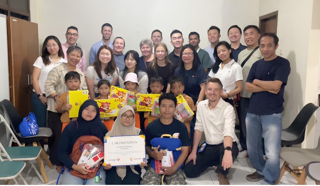 vinci energies employees posed for a photo with representatives of the children from the xsproject foundation to present them with backpacks and school supplies